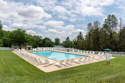 a swimming pool with lounge chairs and a bunch ofitures at Spring Gulch Lodge 11 in Mount Airy