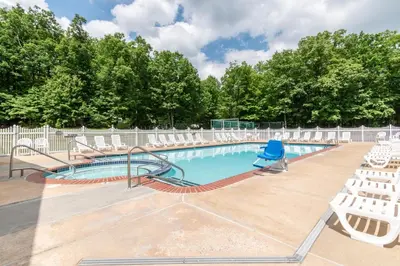 a swimming pool with chairs and a slide at Spring Gulch Chalet 12 in Mount Airy