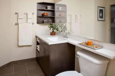 a bathroom with a sink and a toilet and a mirror at Sonesta Simply Suites Somerset in Somerset