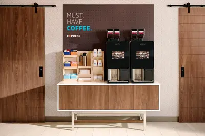 a coffee shop with a counter with a coffee maker on it at Holiday Inn Express Philadelphia NE - Langhorne by IHG in Langhorne
