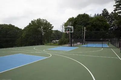 a basketball hoop on a tennis court at Circle M Camping Resort Loft Park Model in Wabank