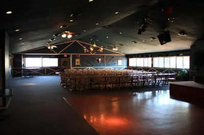 a large room with tables and chairs in a building at Circle M Camping Resort Screened Park Model in Wabank