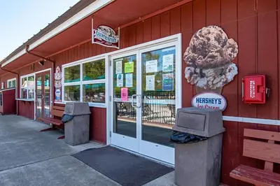a store with a sign on the side of a building at Hershey Camping Resort Loft Park Model 7 in Mount Wilson