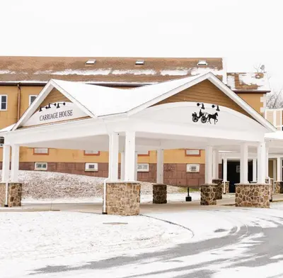 a building with a pavilion in the snow at Carriage House Country Club in Pocono Manor