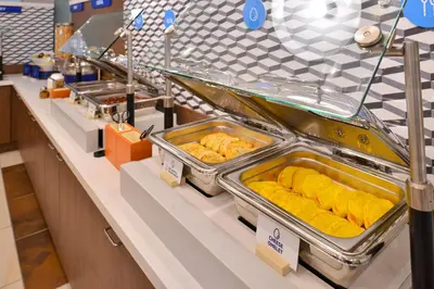 a buffet line with trays of food on display at Holiday Inn Express Philadelphia NE-Bensalem by IHG in Bensalem