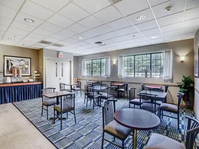 a restaurant with tables and chairs in a room at Scottish Inn Whippany in Whippany