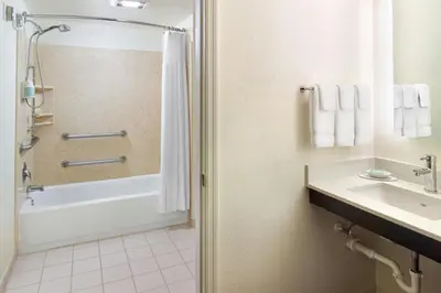 a bathroom with a tub shower and a sink at Residence Inn Cranbury South Brunswick in Cranbury