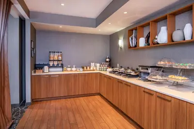 a kitchen with a counter with food on it at SpringHill Suites by Marriott Hershey Near The Park in Hershey