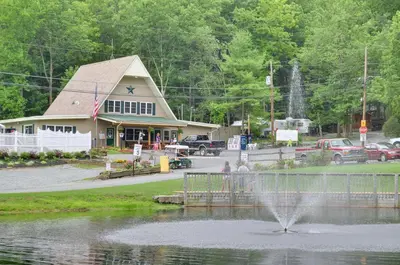 a fountain in the middle of a pond in front of a building at Sun Valley Campground Cottage 4 in Maple Grove Park