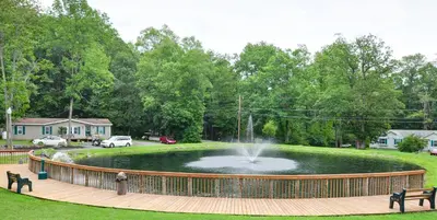 a pond with a fountain in the middle of a park at Sun Valley Campground Cottage 4 in Maple Grove Park