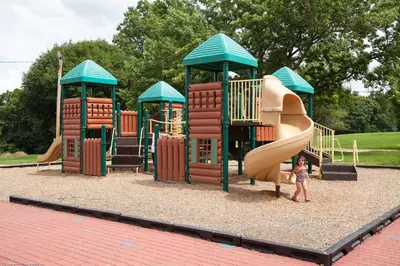 a child standing in front of a playground at Circle M Camping Resort Yurt in Lancaster