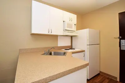 a small kitchen with a sink and a white refrigerator at Extended Stay America Suites - Elizabeth - Newark Airport in Elizabeth