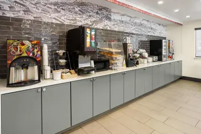 a kitchen with a counter with aasteryasteryasteryasteryasteryasteryasteryasteryastery at Ramada by Wyndham York Harrisburg Hershey in York