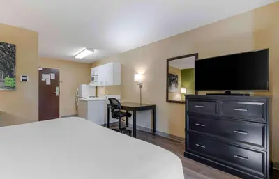 a hotel room with a bed and a flat screen tv at Extended Stay America Suites - Meadowlands - East Rutherford in East Rutherford