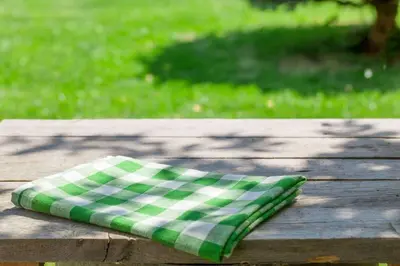 a green and white pillow sitting on a wooden table at Extended Stay America Suites - Meadowlands - East Rutherford in East Rutherford