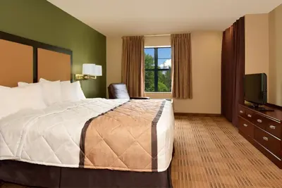 a hotel room with a bed and a television at Extended Stay America Suites - Princeton - South Brunswick in South Brunswick Terrace