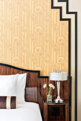 a bedroom with a bed and a table with a lamp at Walker Hotel Greenwich Village in New York