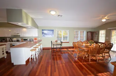 a kitchen and dining room with a table and chairs at Mt. Maplewood Split Chalet in Pocono Lake