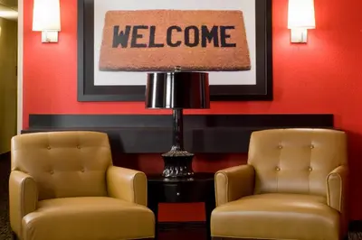 two chairs and a lamp in a waiting room at Extended Stay America Suites - Edison - Raritan Center in Edison