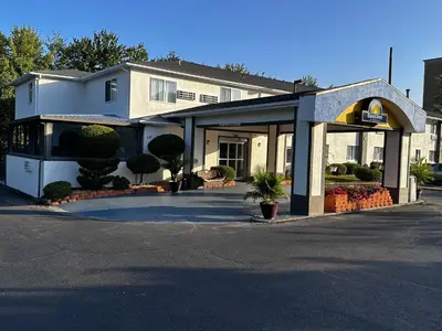 a building with a sign in front of it at Days Inn by Wyndham Runnemede Philadelphia Area in Runnemede