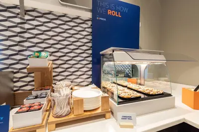 a display case with donuts and other pastries at Holiday Inn Express & Suites Carlisle - Harrisburg Area by IHG in Carlisle