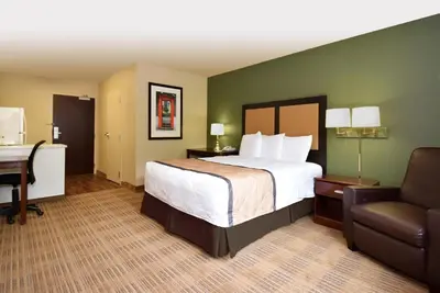a hotel room with a bed and a desk and a chair at Extended Stay America Suites - Philadelphia - Cherry Hill in Maple Shade