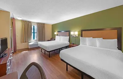a hotel room with two beds and a television at Extended Stay America Suites - Somerset - Franklin in Somerset