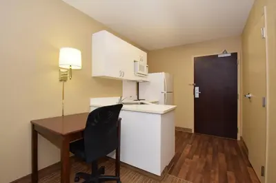 a small kitchen with a desk and a refrigerator at Extended Stay America Select Suites - Philadelphia - Malvern - Great Valley in Malvern