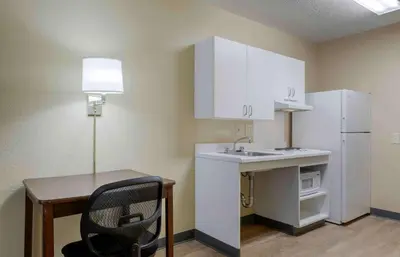 a small kitchen with a desk and a white refrigerator at Extended Stay America Suites - Philadelphia - Horsham - Welsh Rd in Horsham