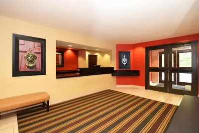 a waiting room with red walls and a mirror at Extended Stay America Suites - Philadelphia - Horsham - Welsh Rd in Horsham