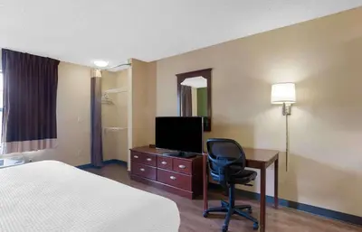 a hotel room with a bed and a desk with a television at Extended Stay America Suites - Philadelphia - Horsham - Dresher Rd in Horsham