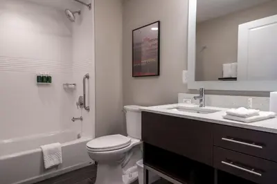 a white bathroom with a toilet and a sink at TownePlace Suites by Marriott Clinton in Clinton