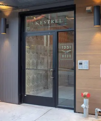a store front with a glass door with a fire hydrant in front at Billy Penn Studio at Kestrel Hotel in Philadelphia