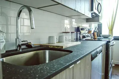 a kitchen with a sink and a counter top at Rail Park Studio at Kestrel Hotel in Philadelphia