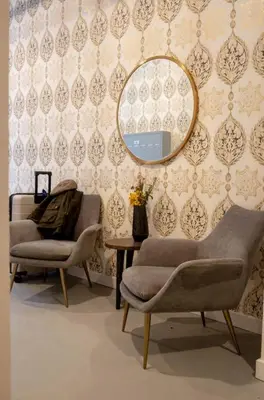 a room with a mirror and two chairs and a table at Inquirer Studio at Kestrel Hotel in Philadelphia