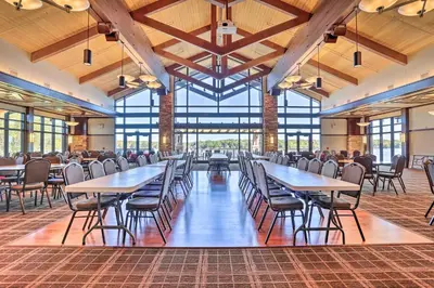 a dining hall with tables and chairs and windows at Resort Amenities and Game Room Arrowhead Lake Home! in Pocono Lake