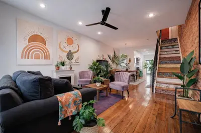 a living room with a couch and a fireplace at Artsy Hidden Gem --- FREE PARKING in Philadelphia