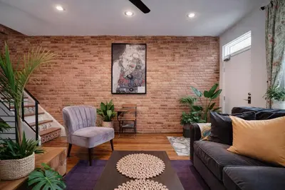 a living room with a brick wall at Artsy Hidden Gem - FREE PARKING in Philadelphia