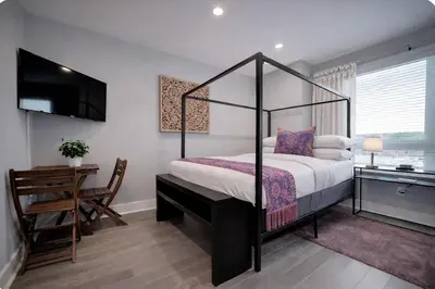 a bedroom with a canopy bed and a desk at Artsy Hidden Gem ll -Free Parking --- in Philadelphia
