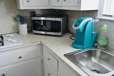 a kitchen counter with a sink and a microwave at Bright & cozy * 2nd Floor Apartment*. Close to NYC in Bloomfield
