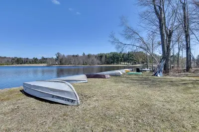 a group of boats sitting on the shore of a lake at Shared Boat Launch Lake Retreat in Ellenville! in Ellenville