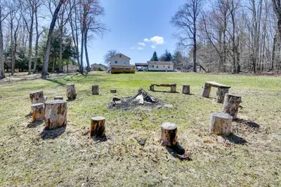 a group of tree stumps in the middle of a field at Shared Fire Pit and Kayaks Catskills Lake Retreat! in Ellenville