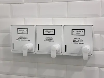 two electrical outlets on a white tiled wall at The Ledger Residences by Sosuite - Old City in Philadelphia