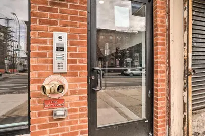 a door to a brick building with a sign on it at Central Pet-Friendly Apt - Minutes to Dtwn! in Philadelphia