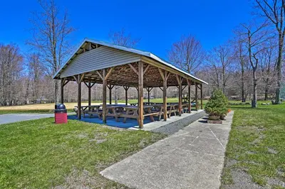 a picnic pavilion with benches in a park at 7 Mi to Tobyhanna State Park Quiet Retreat! in Tobyhanna