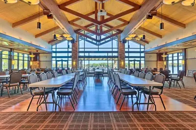 a large dining room with tables and chairs at Peaceful Pocono Lakefront, beach, pools, firepit, pets in Arrowhead Lake