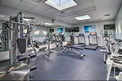 a gym with several tread machines in a room at Ian's Camelback House in Tannersville