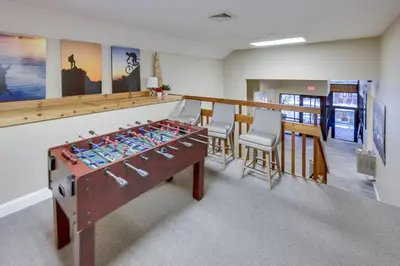a room with a ping pong table and chairs at Garrett's Camelback House in Tannersville