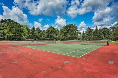 a tennis court with two tennis rackets on it at Less Than 7 Mi to Slopes Inviting Pocono Mtn Retreat! in Albrightsville
