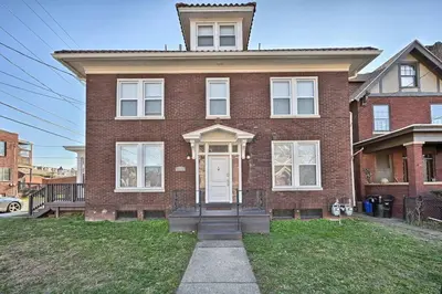 a red brick house with a white door at Suites on Seneca - Lovely 2 Bed 1 Bath Apartment in Harrisburg
